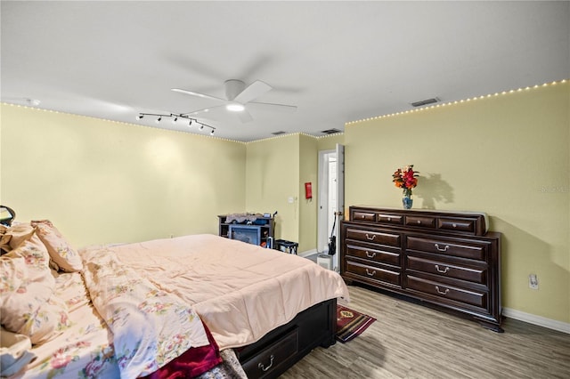 bedroom with light hardwood / wood-style flooring and ceiling fan