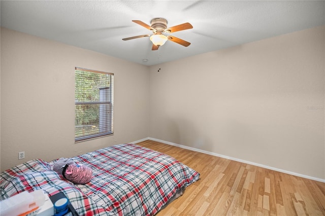 bedroom with ceiling fan and light wood-type flooring