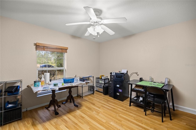 home office featuring light wood-type flooring and ceiling fan