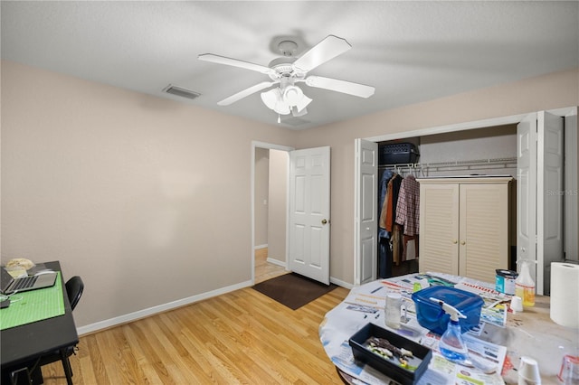 bedroom with ceiling fan, a closet, and hardwood / wood-style floors