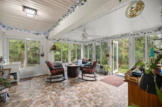 sunroom / solarium featuring ceiling fan