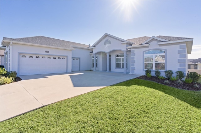 ranch-style house with a garage and a front lawn