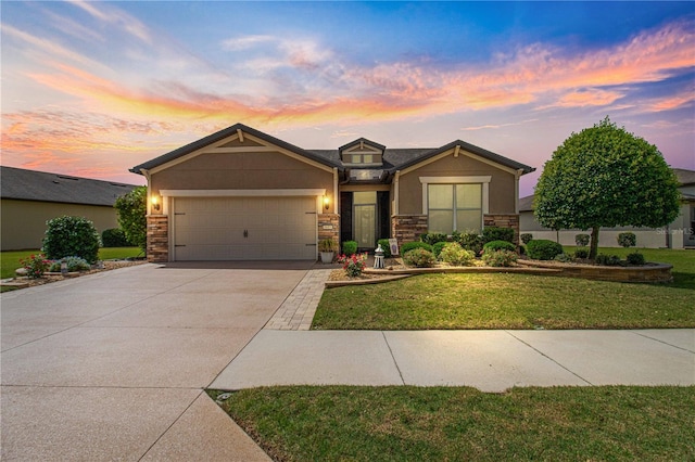 craftsman house with a lawn and a garage