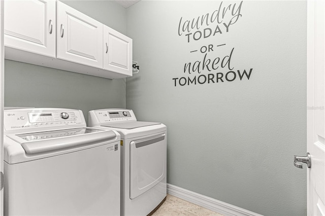 washroom featuring light tile patterned flooring, cabinets, and independent washer and dryer