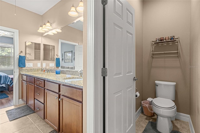 bathroom featuring tile patterned floors, vanity, and toilet