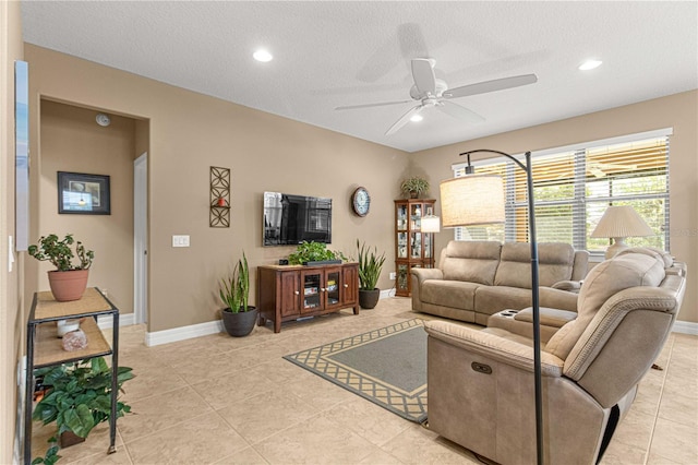 living room featuring light tile patterned floors, a textured ceiling, and ceiling fan