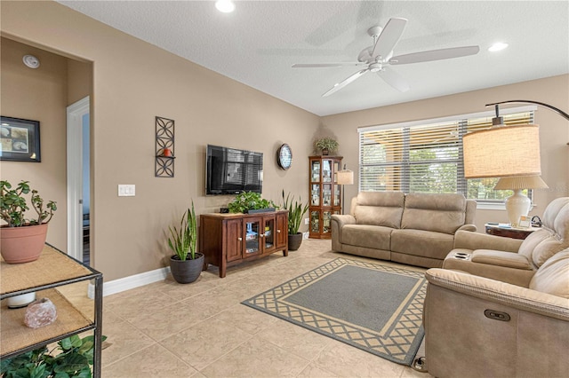 tiled living room with ceiling fan and a textured ceiling