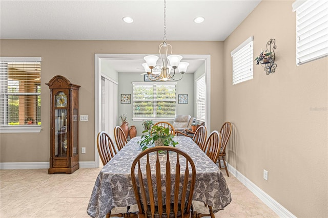 tiled dining space with a chandelier