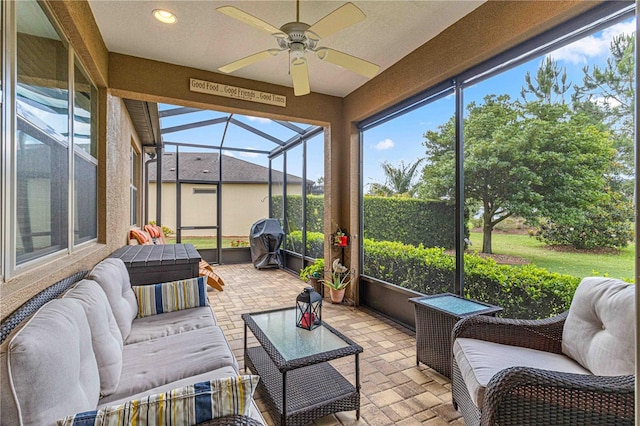 sunroom / solarium featuring ceiling fan