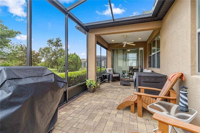 sunroom featuring ceiling fan