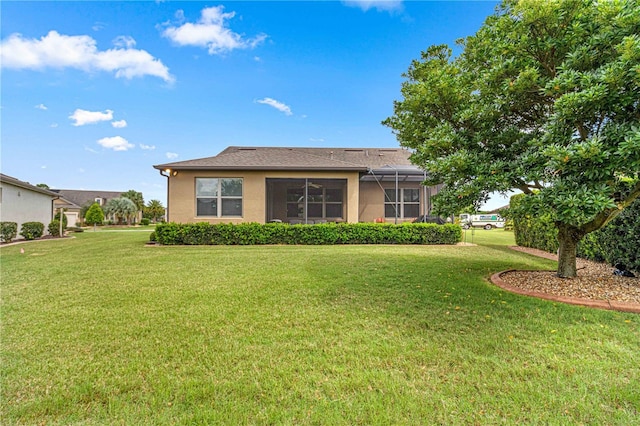 back of house featuring a lanai and a lawn