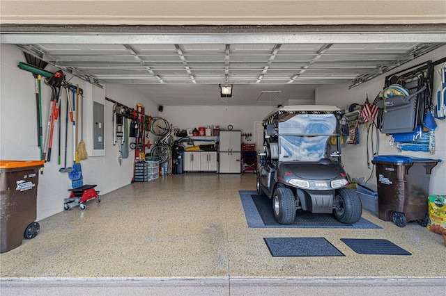 garage with electric panel and a garage door opener