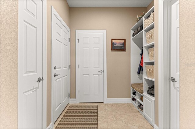 mudroom featuring light tile patterned flooring