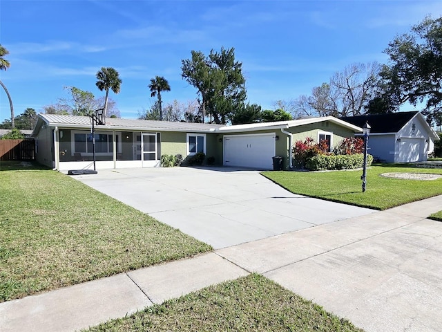 single story home featuring a garage and a front yard