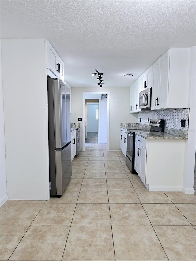 kitchen featuring white cabinetry, a textured ceiling, and appliances with stainless steel finishes