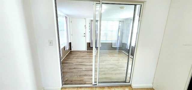 hall featuring a textured ceiling