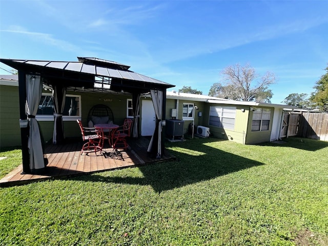 back of house featuring a gazebo, a yard, central AC, and a wooden deck