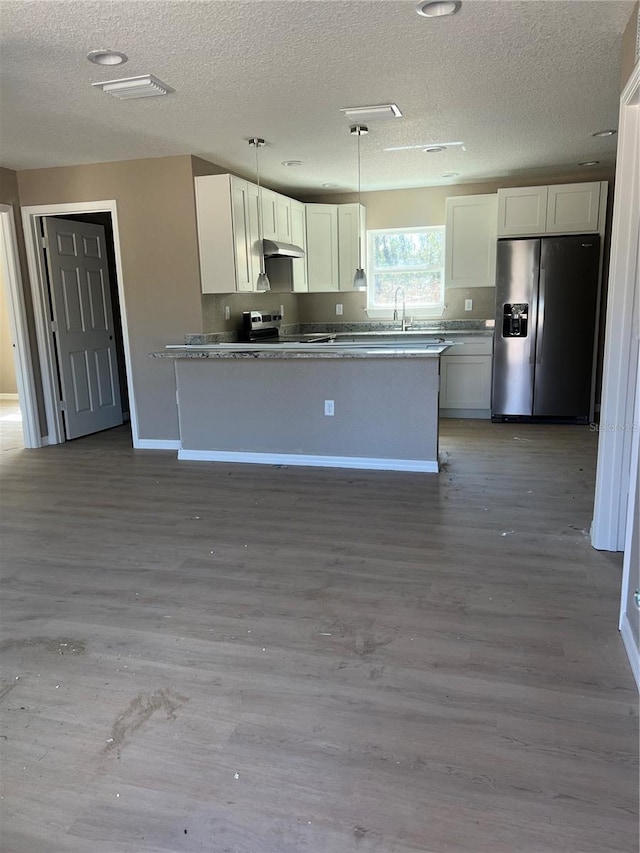 kitchen featuring sink, hardwood / wood-style flooring, pendant lighting, stainless steel appliances, and white cabinets