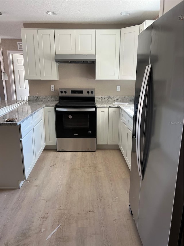 kitchen featuring white cabinetry, light stone counters, stainless steel appliances, a textured ceiling, and light hardwood / wood-style flooring