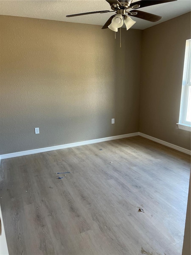 unfurnished room with wood-type flooring and ceiling fan