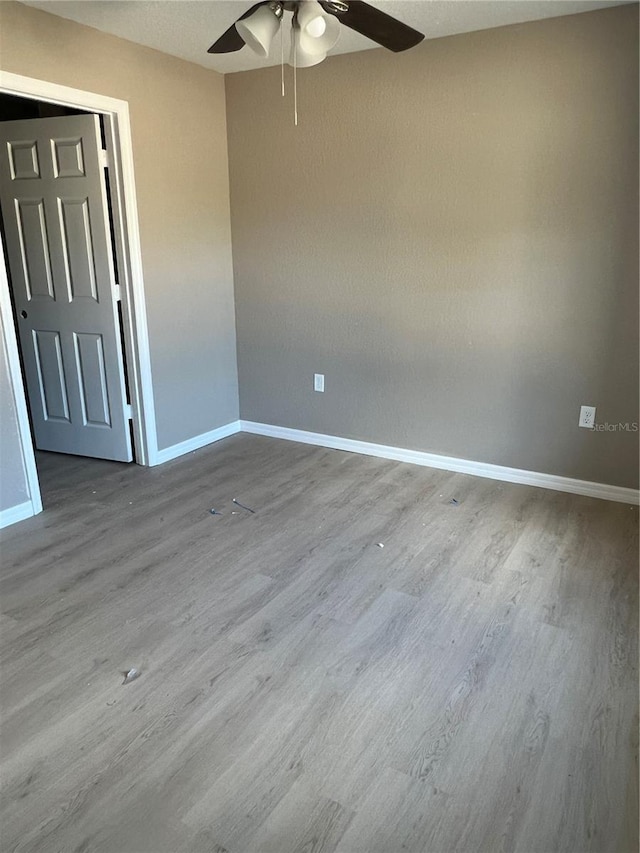 unfurnished room featuring hardwood / wood-style flooring and ceiling fan