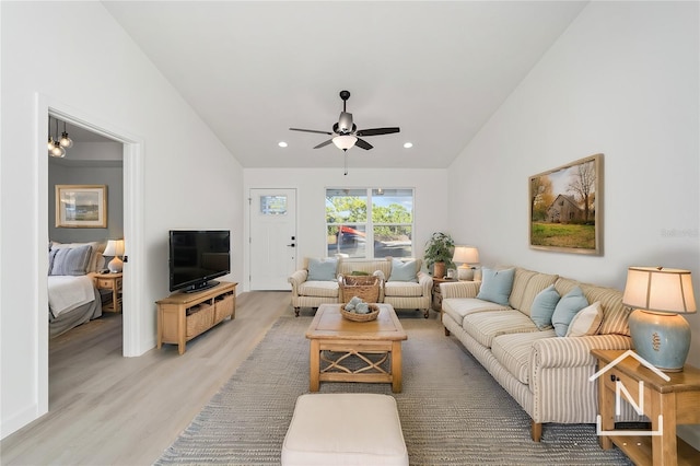 living room featuring wood-type flooring, ceiling fan, and lofted ceiling