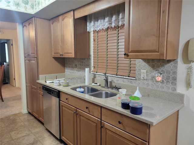 kitchen with sink, light stone counters, decorative backsplash, and stainless steel dishwasher