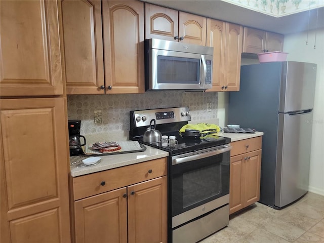 kitchen with decorative backsplash and appliances with stainless steel finishes