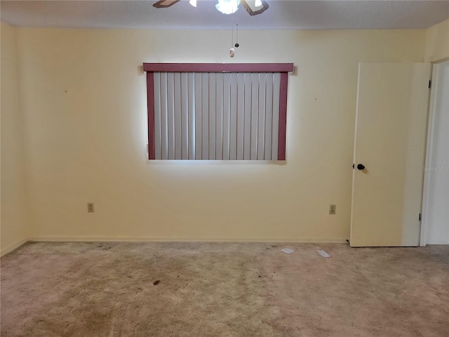 empty room with carpet flooring and ceiling fan