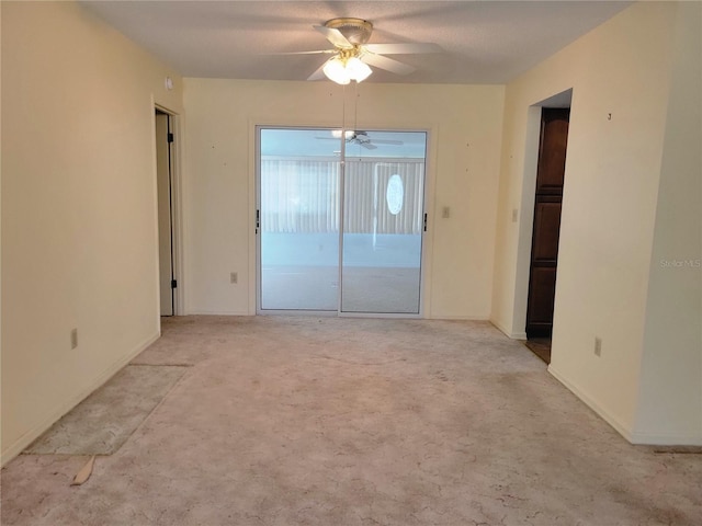 empty room featuring light carpet and ceiling fan