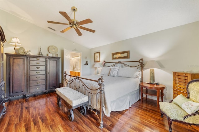 bedroom with ensuite bath, vaulted ceiling, ceiling fan, and hardwood / wood-style flooring