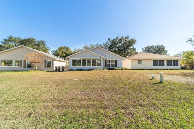 back of property with a lawn