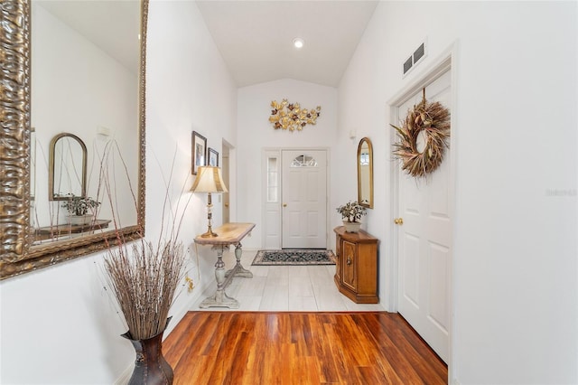 interior space with hardwood / wood-style flooring and high vaulted ceiling