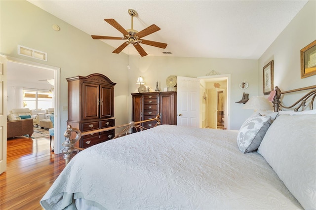 bedroom featuring ceiling fan, wood-type flooring, and lofted ceiling