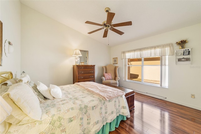 bedroom with ceiling fan, dark wood-type flooring, and vaulted ceiling