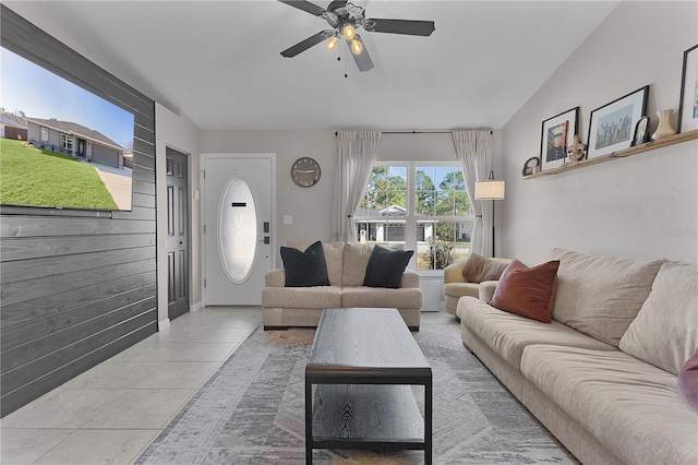 tiled living room with ceiling fan