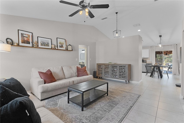 living room with ceiling fan, light tile patterned floors, and vaulted ceiling