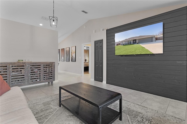 living room with light tile patterned floors and vaulted ceiling