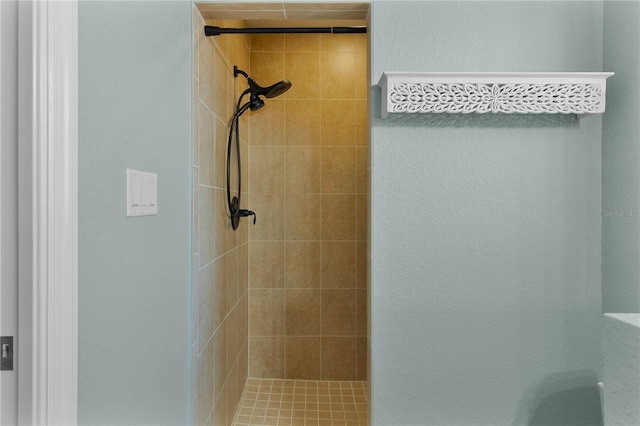 bathroom with tiled shower