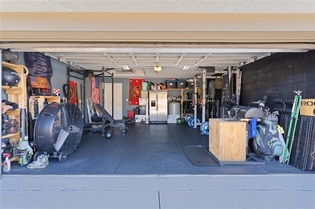 garage with stainless steel fridge with ice dispenser