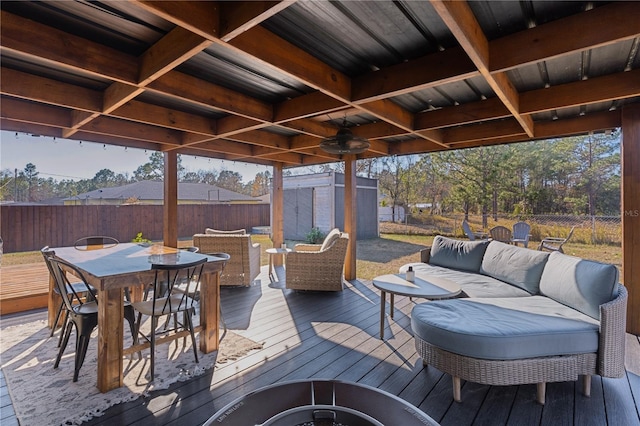 wooden terrace featuring outdoor lounge area and a storage shed