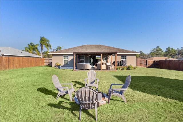 rear view of property featuring an outdoor living space, a patio, and a lawn