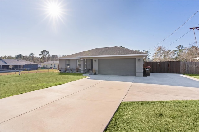 single story home featuring a garage and a front lawn