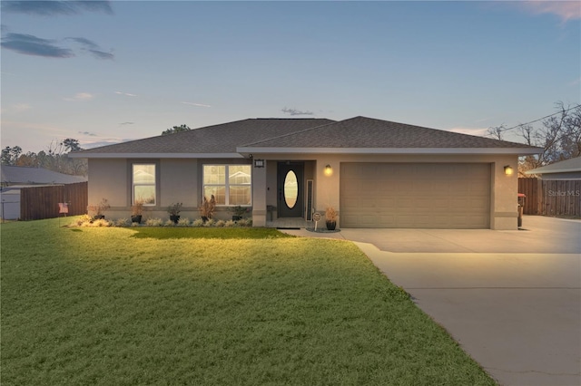 view of front of property featuring a lawn and a garage