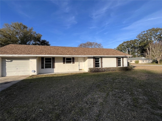 ranch-style house featuring a garage and a front yard