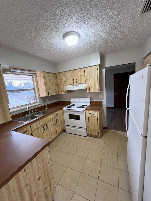 kitchen featuring white appliances, light brown cabinetry, a textured ceiling, light tile patterned floors, and sink