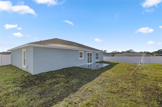 rear view of house with a lawn