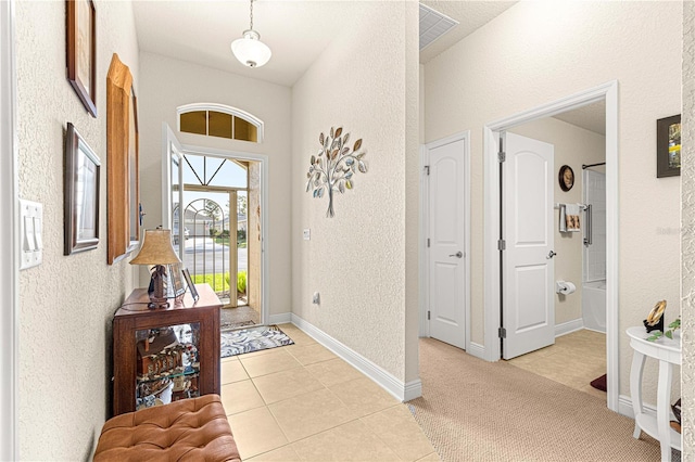 foyer with light colored carpet