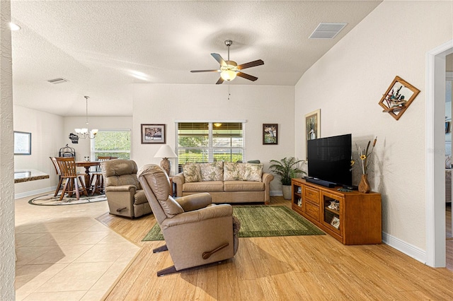 living room with a textured ceiling, light hardwood / wood-style floors, and plenty of natural light