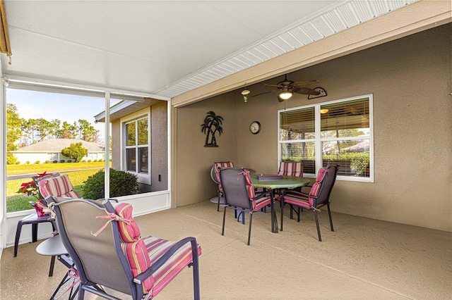 sunroom featuring ceiling fan